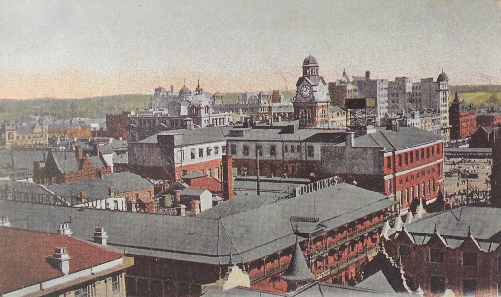 Early aerial view of the Standard Theatre showing the Rissik Street Post office behind
